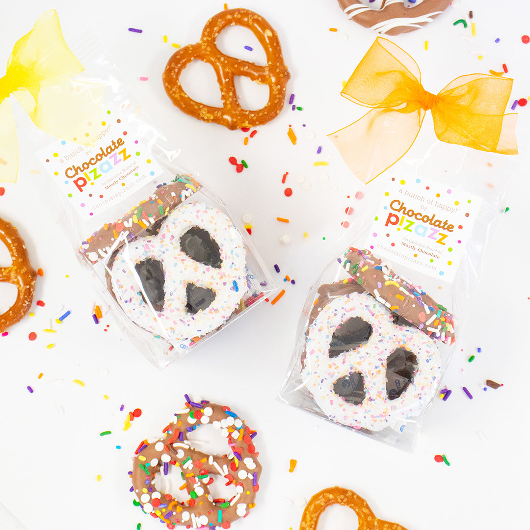Chocolate pizzas with sprinkles and pretzels on a white background with 'Chocolate Pizazz' branding.