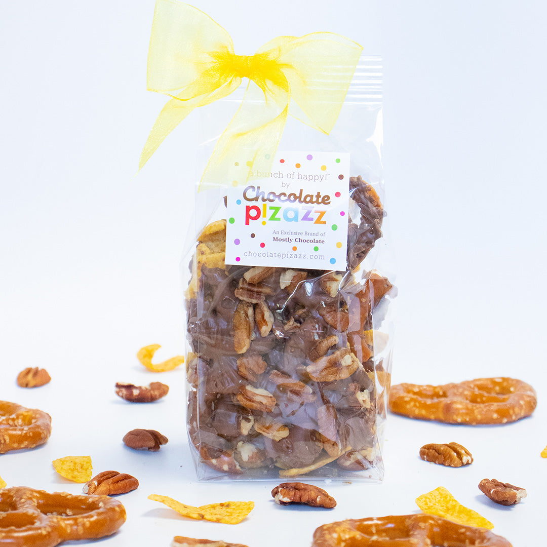 Packaged snack mix with a yellow bow and 'Chocolate Pizazz' label on a white background