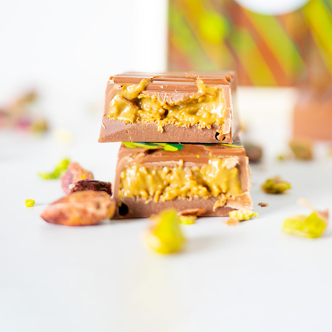 Two chocolate bars with peanut butter filling on a white surface