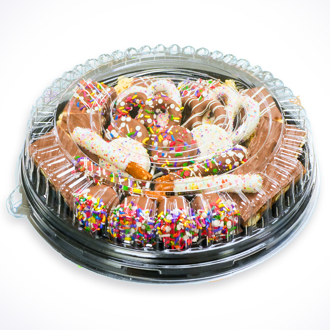 Plastic container with pretzels and colorful sprinkles on a white background