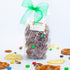 Bag of chocolate covered pretzels with a green bow and 'Chocolate Fizzazz' label on a white background.
