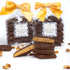 Stack of chocolate-covered toffee with a yellow bow and visible pecans on a white background
