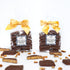 Two packages of Dark Chocolate Texas Pecan Toffee with yellow ribbons on a white background.