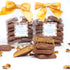 Chocolate-covered candies with a stack in front and wrapped candies with yellow bows in the background.
